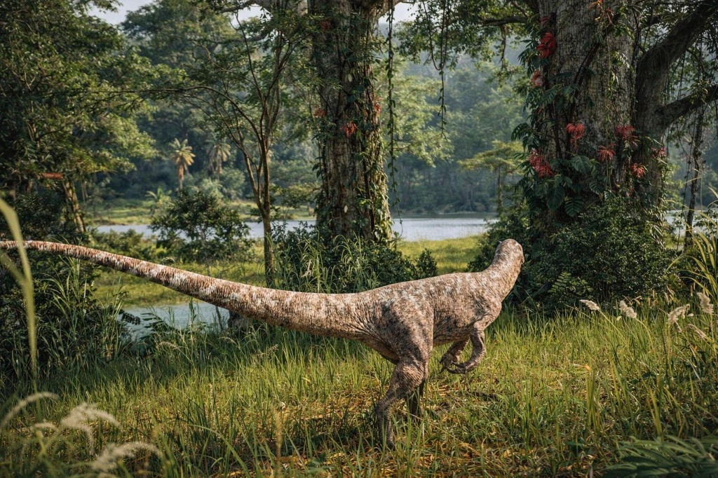 A dinosaur stalking through tall grass on a riverbank in The Isle Evrima, with vine-covered trees and red flowers in the background.